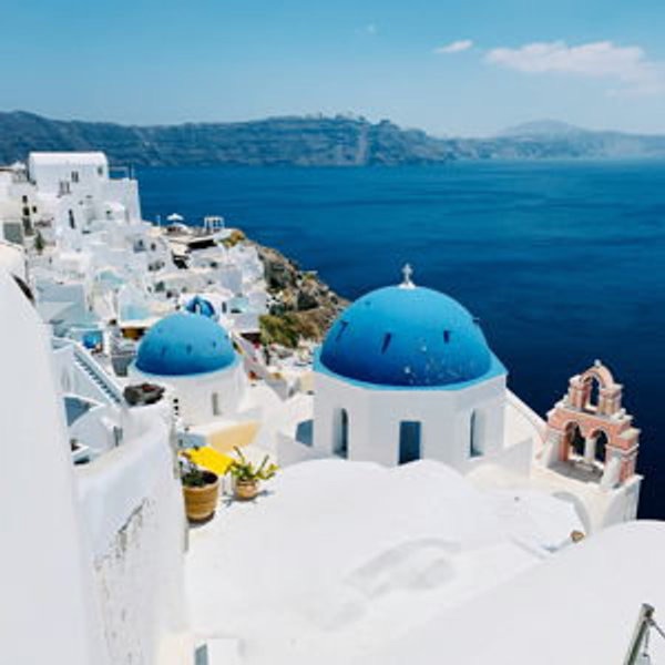 White buildings and blue domes above the sea in Santorini